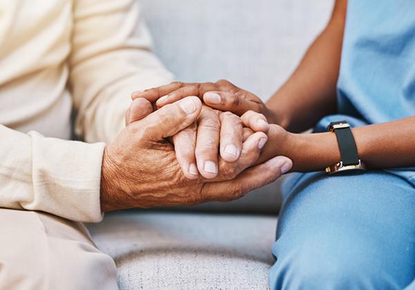 Two people holding hands